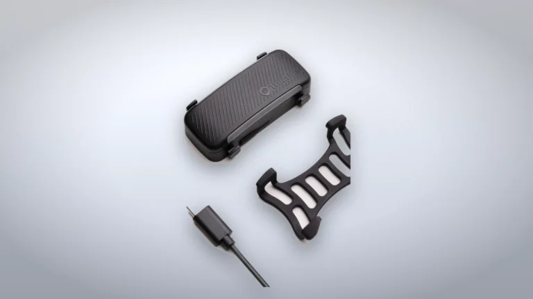 Tractive DOG 6 tracker with its collar clip and charging cable