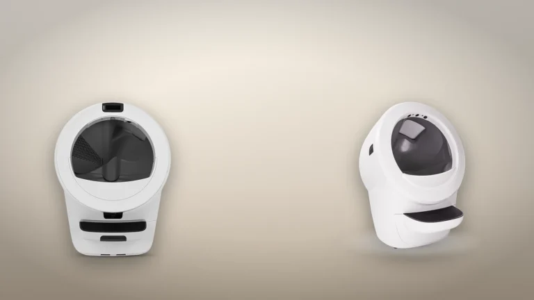White Litter-Robot 5 Pro seen from the front beside a white Litter-Robot 4 seen at an angle, on a neutral backdrop